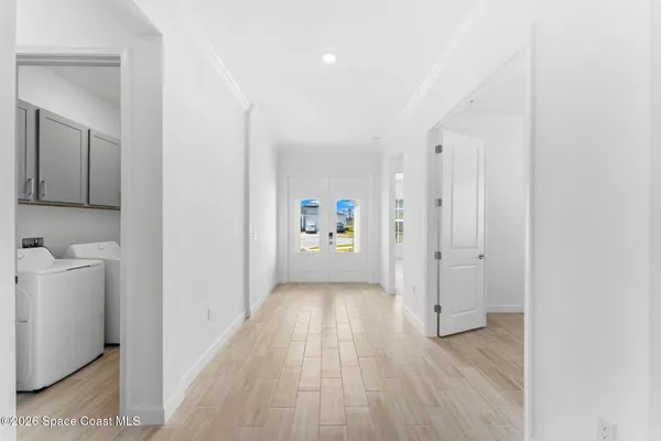 a view of a hallway with wooden floor