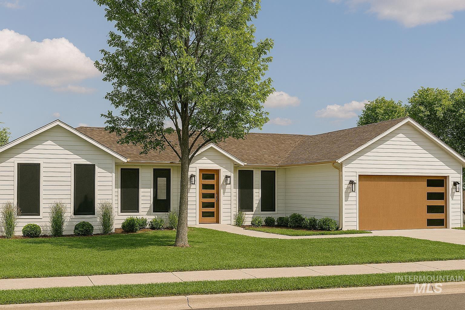 780 Victoria Drive Moscow, ID 83843 - Photo 2 of 25 View of front facade featuring a shingled roof, an attached garage, a front lawn, and driveway