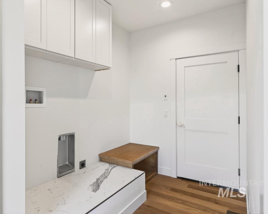 780 Victoria Drive Moscow, ID 83843 - Photo 29 of 44 Laundry area featuring dark wood-style floors, recessed lighting, hookup for a washing machine, and cabinet space