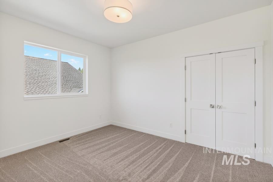 780 Victoria Drive Moscow, ID 83843 - Photo 39 of 44 Unfurnished bedroom with light colored carpet and a closet