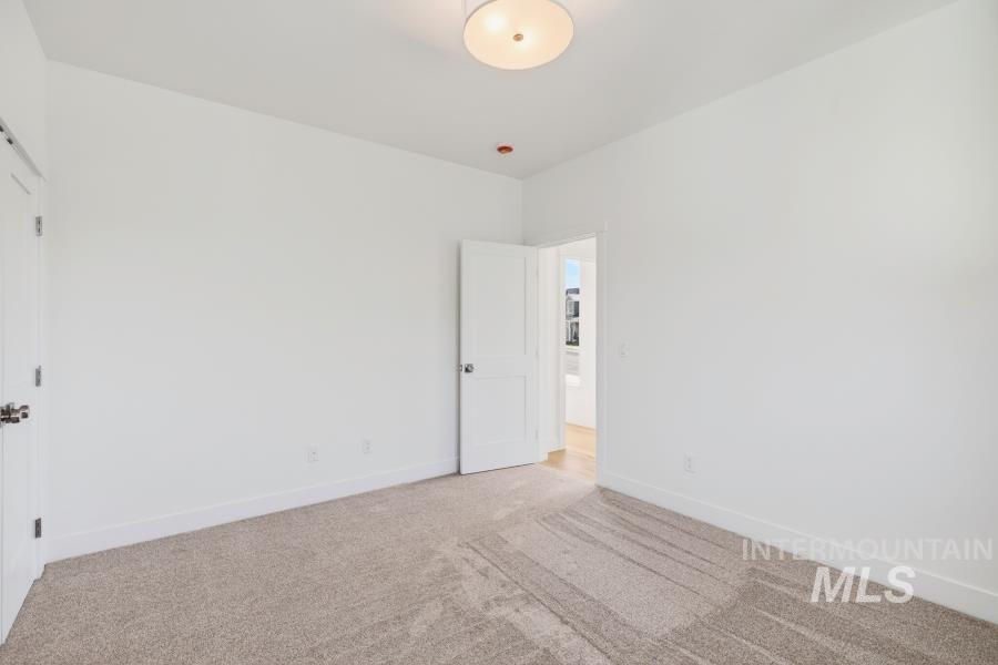 780 Victoria Drive Moscow, ID 83843 - Photo 40 of 44 Empty room with light colored carpet and baseboards
