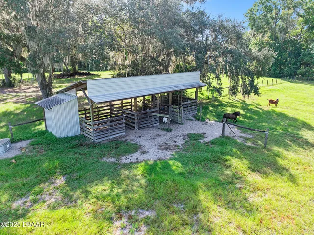 a view of a backyard with table and chairs with a yard