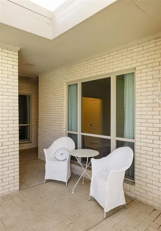 a patio with a chair and table