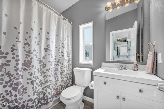 a bathroom with a sink toilet and mirror