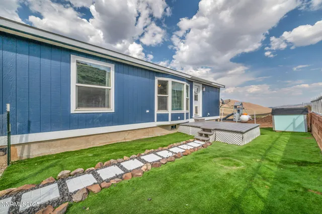 a backyard of a house with table and chairs
