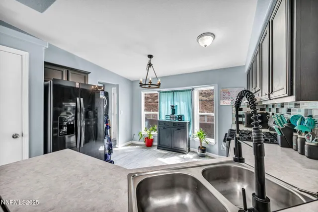 a kitchen with a refrigerator and a sink