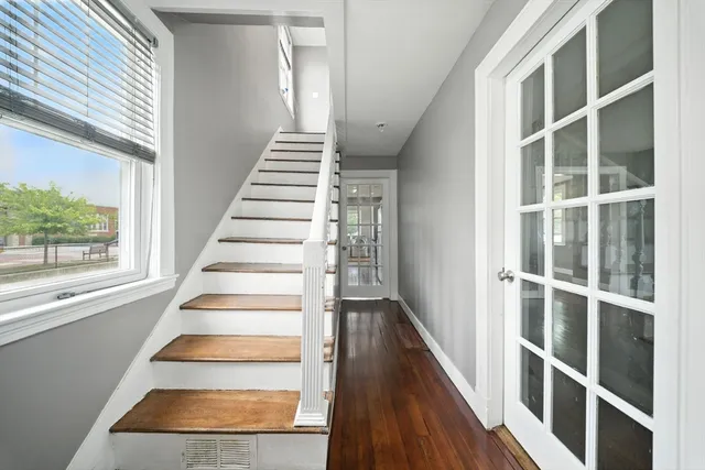a view of entryway and hall with wooden floor