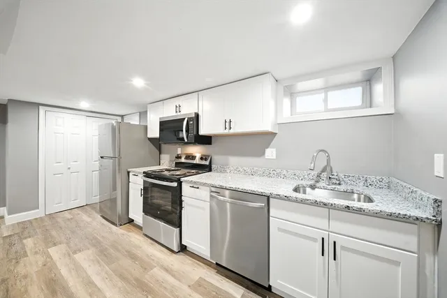 a kitchen with a sink stove and refrigerator