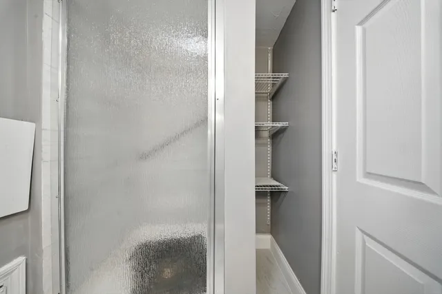 a bathroom with a glass shower door