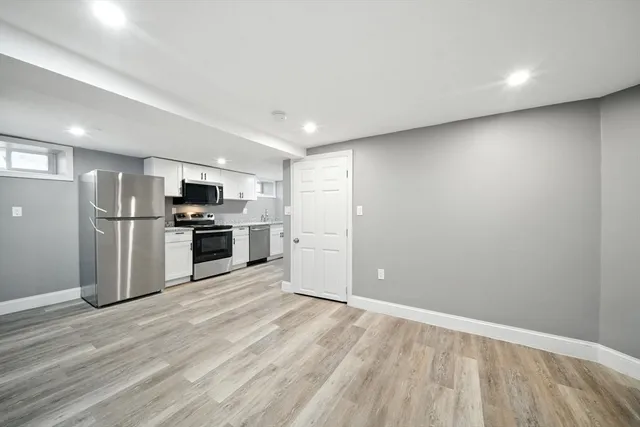 a kitchen with stainless steel appliances a refrigerator and a stove top oven
