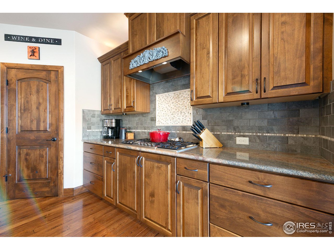 6701 Clovis Court Timnath, CO 80547 - Photo 11 of 40 a kitchen with wooden cabinets and a sink
