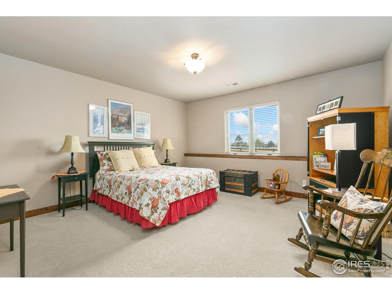 6701 Clovis Court Timnath, CO 80547 - Photo 19 of 40 a bedroom with a bed chair and painting on the wall