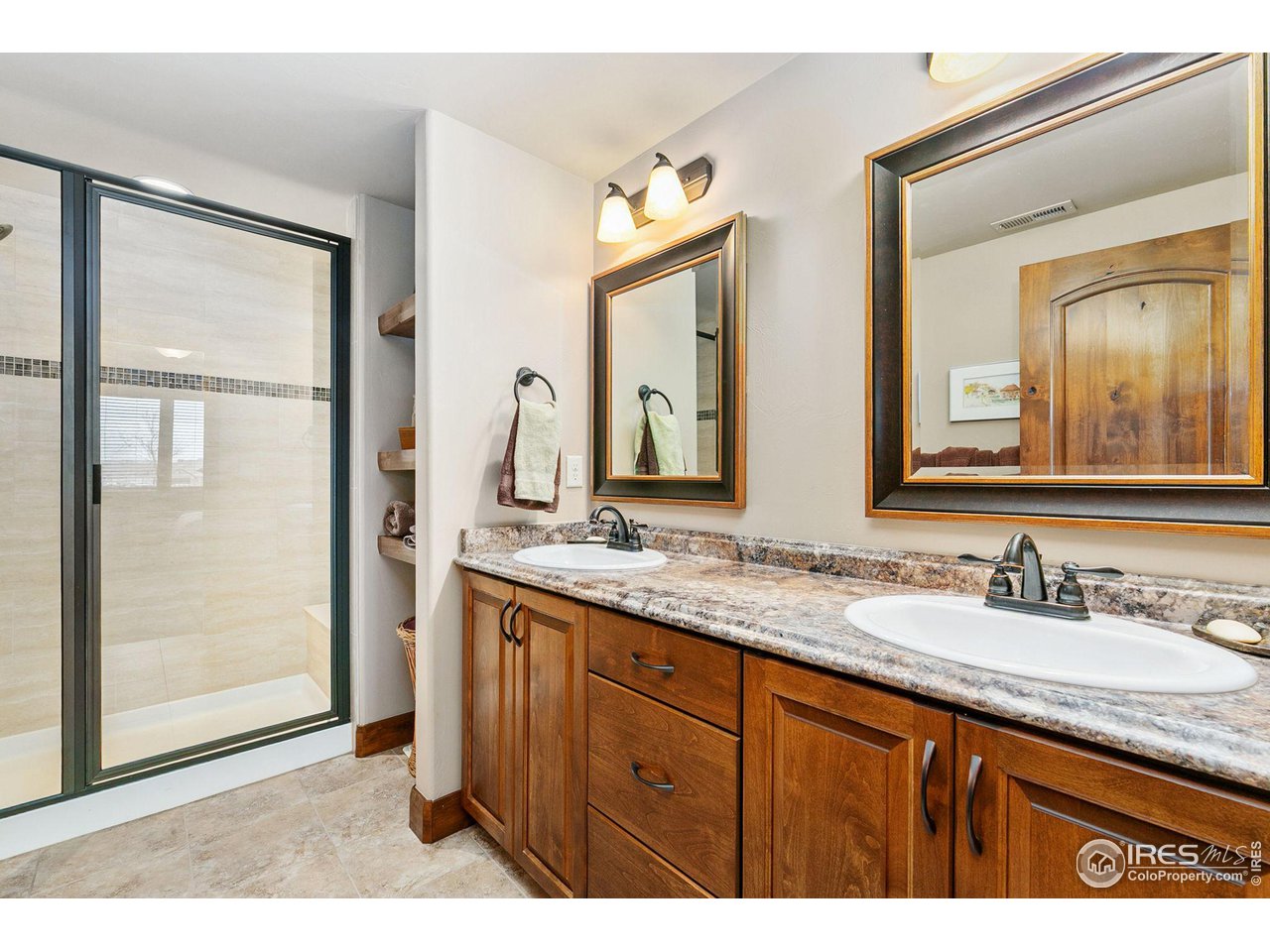 6701 Clovis Court Timnath, CO 80547 - Photo 20 of 40 a bathroom with a granite countertop sink two mirror and a
