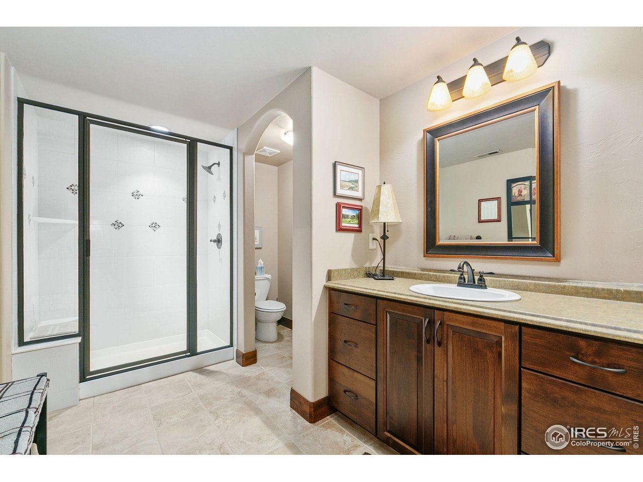 6701 Clovis Court Timnath, CO 80547 - Photo 22 of 40 a bathroom with a sink a mirror and a shower