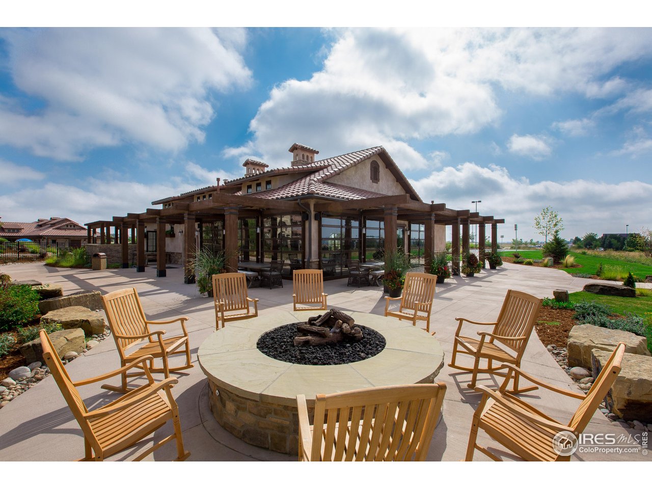 6701 Clovis Court Timnath, CO 80547 - Photo 38 of 40 a view of a patio with couches table and chairs under an umbrella