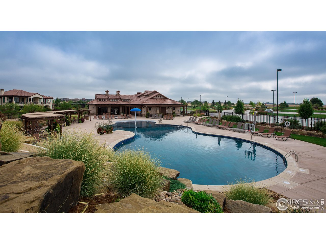 6701 Clovis Court Timnath, CO 80547 - Photo 39 of 40 a balcony with chairs and table with wooden floor