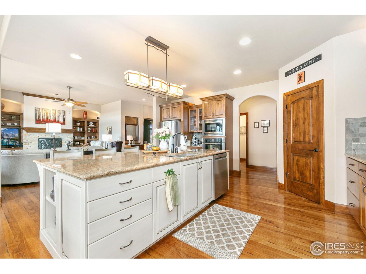 6701 Clovis Court Timnath, CO 80547 - Photo 10 of 40 a kitchen with stainless steel appliances kitchen island granite countertop a refrigerator and a sink