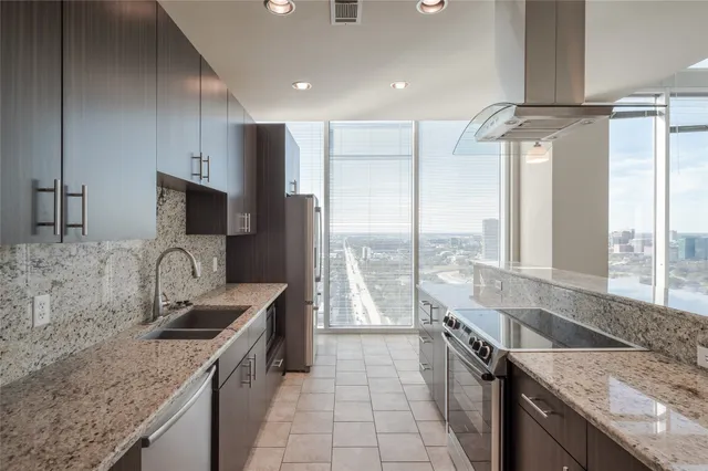 a kitchen with a sink stove top oven and refrigerator