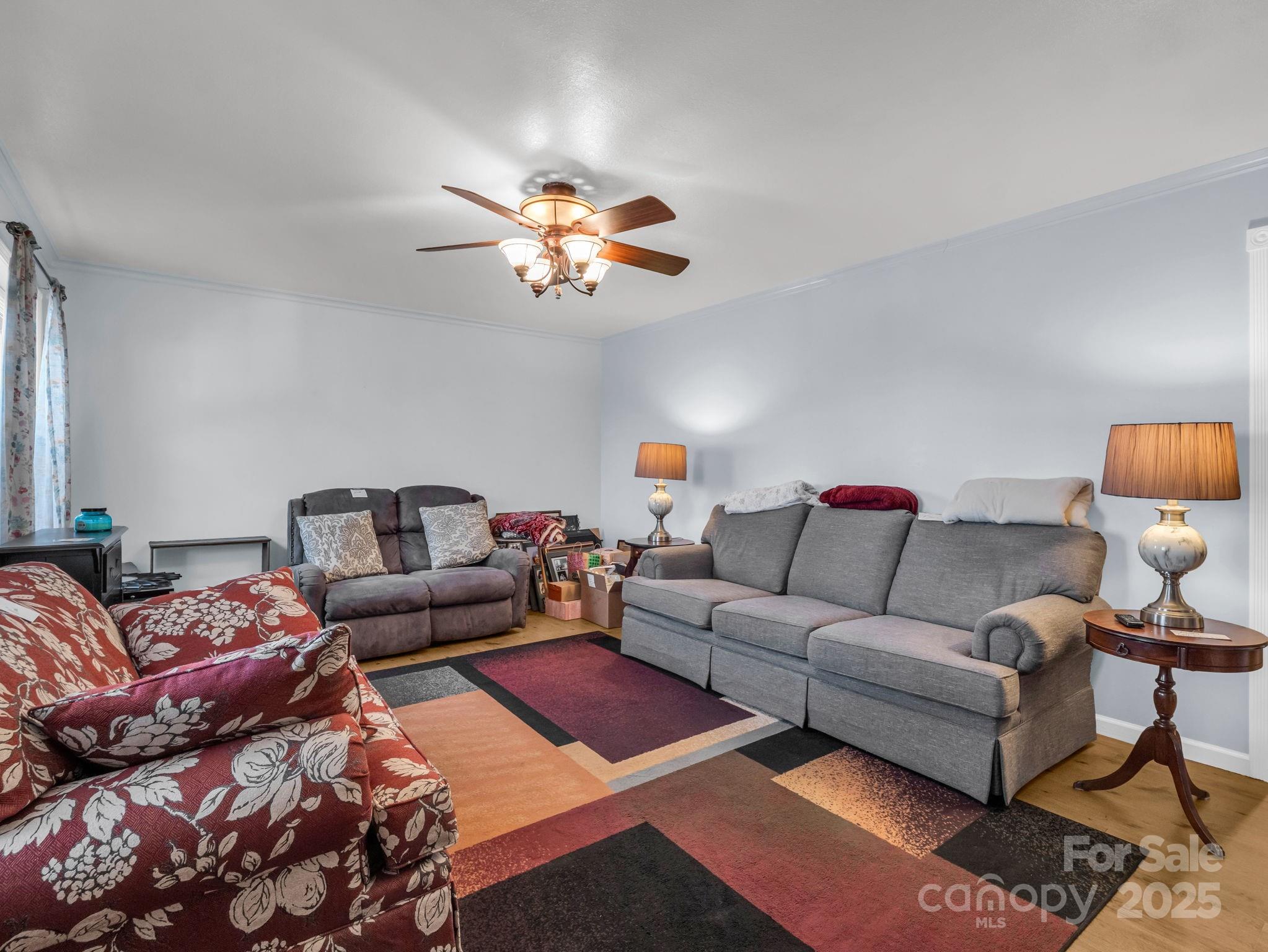 1095 Centennial Road Union Mills, NC 28167 - Photo 27 of 34 a living room with furniture a rug and a chandelier