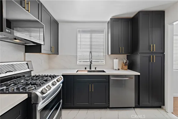 a kitchen with a sink stove and cabinets