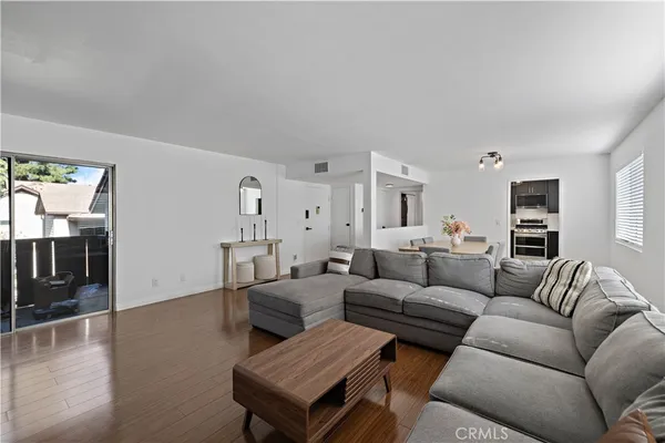 a living room with furniture or couch and a wooden floor