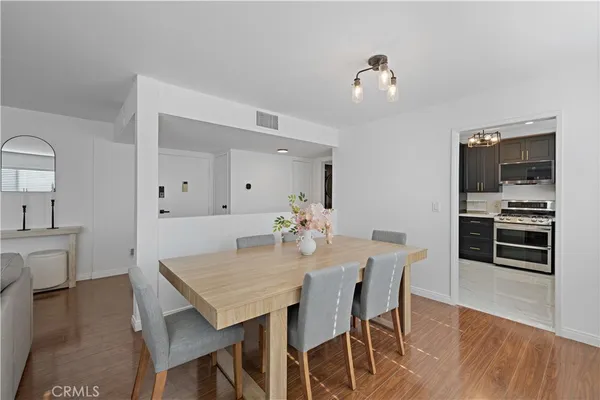 a view of a dining room with furniture and wooden floor