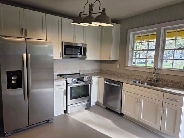 219 Grove Avenue Southeast Lindale, GA 30147 - Photo 4 of 39 a kitchen with stainless steel appliances granite countertop a sink a stove a refrigerator and cabinets