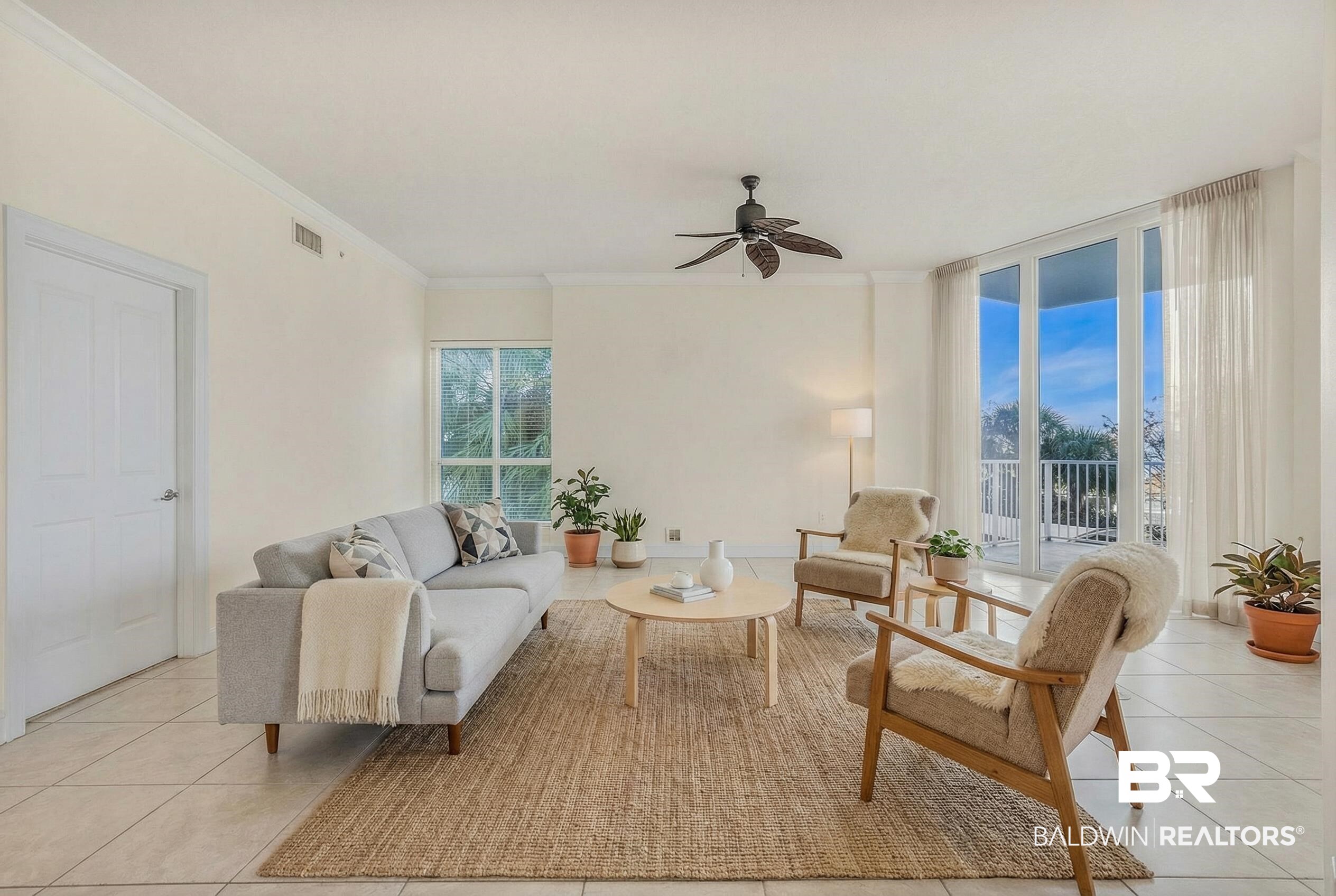 28250 Canal Road, Unit 106 Orange Beach, AL 36561 - Photo 49 of 50 Living room with a ceiling fan, ornamental molding, light tile patterned floors, and expansive windows