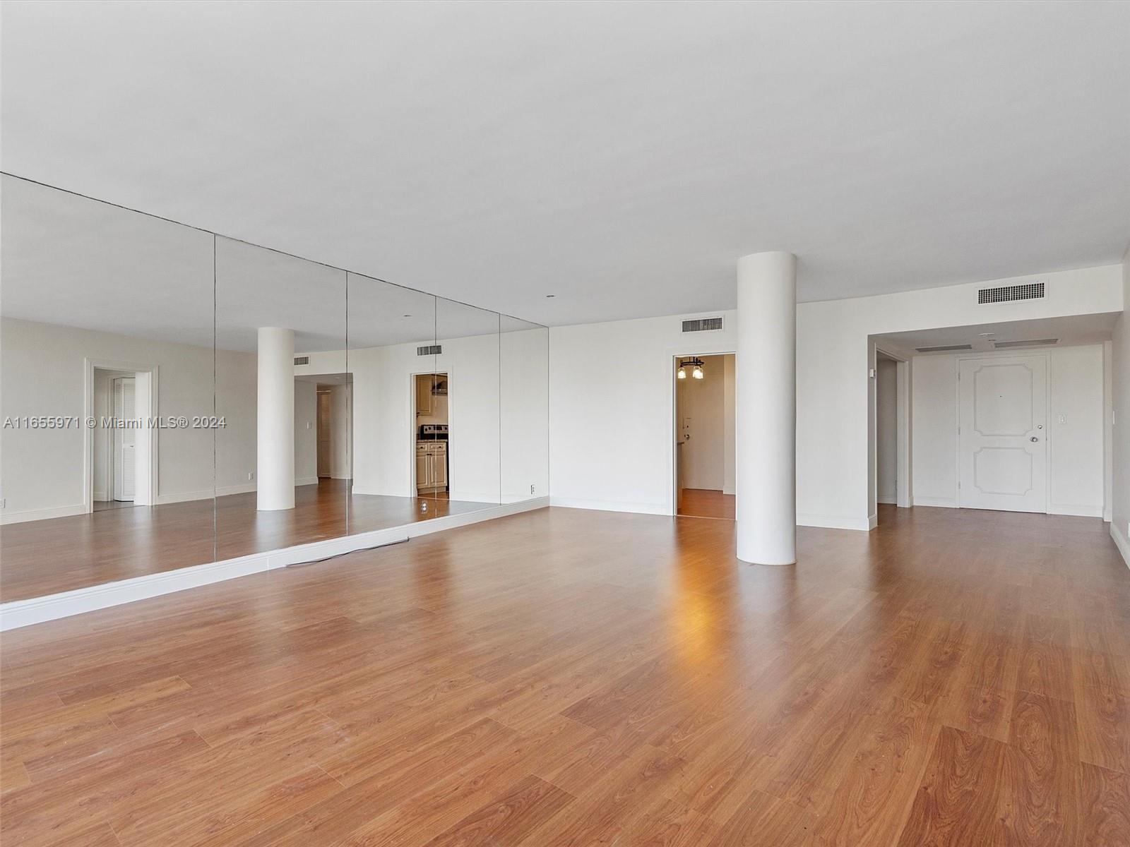 Normandy Isle Miami Beach, FL 33141 - Photo 40 of 43 a view of an empty room with wooden floor and cabinets