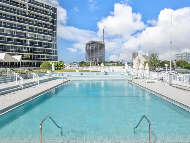 a view of swimming pool with outdoor seating and city view