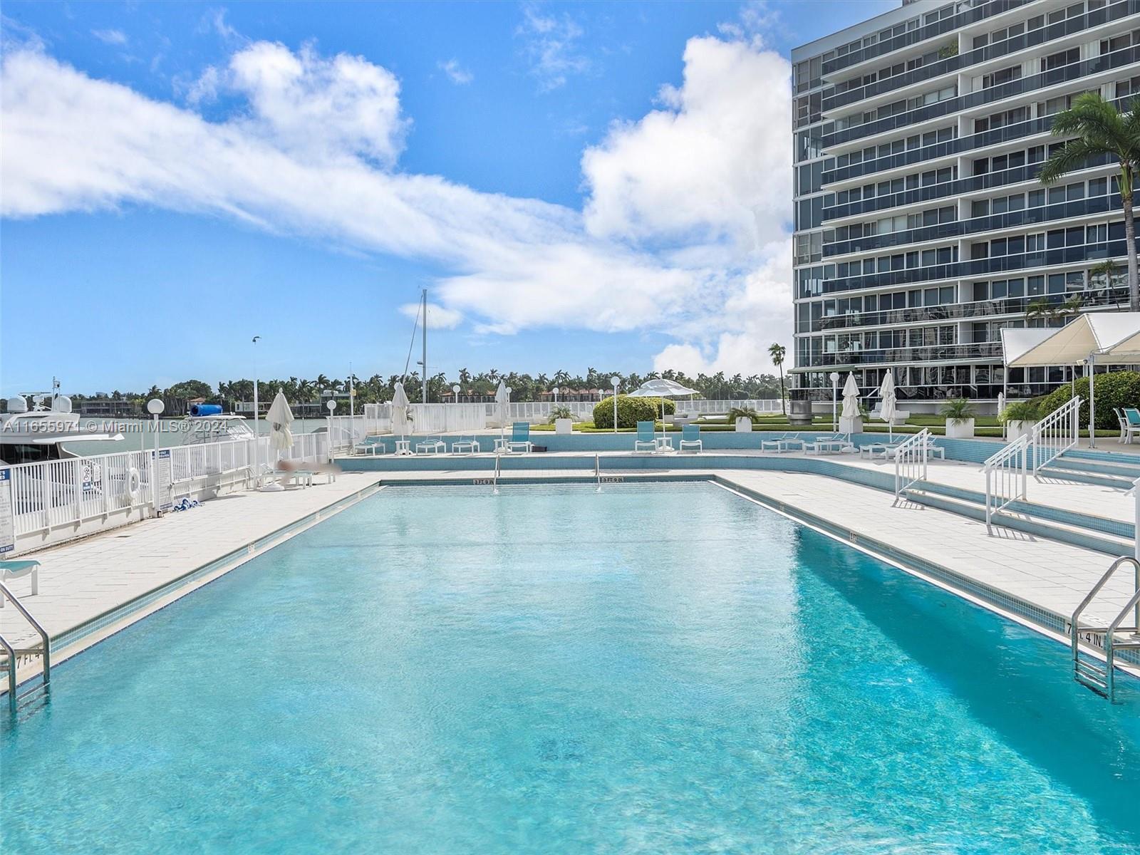 Normandy Isle Miami Beach, FL 33141 - Photo 9 of 43 a view of swimming pool with outdoor seating and yard in back