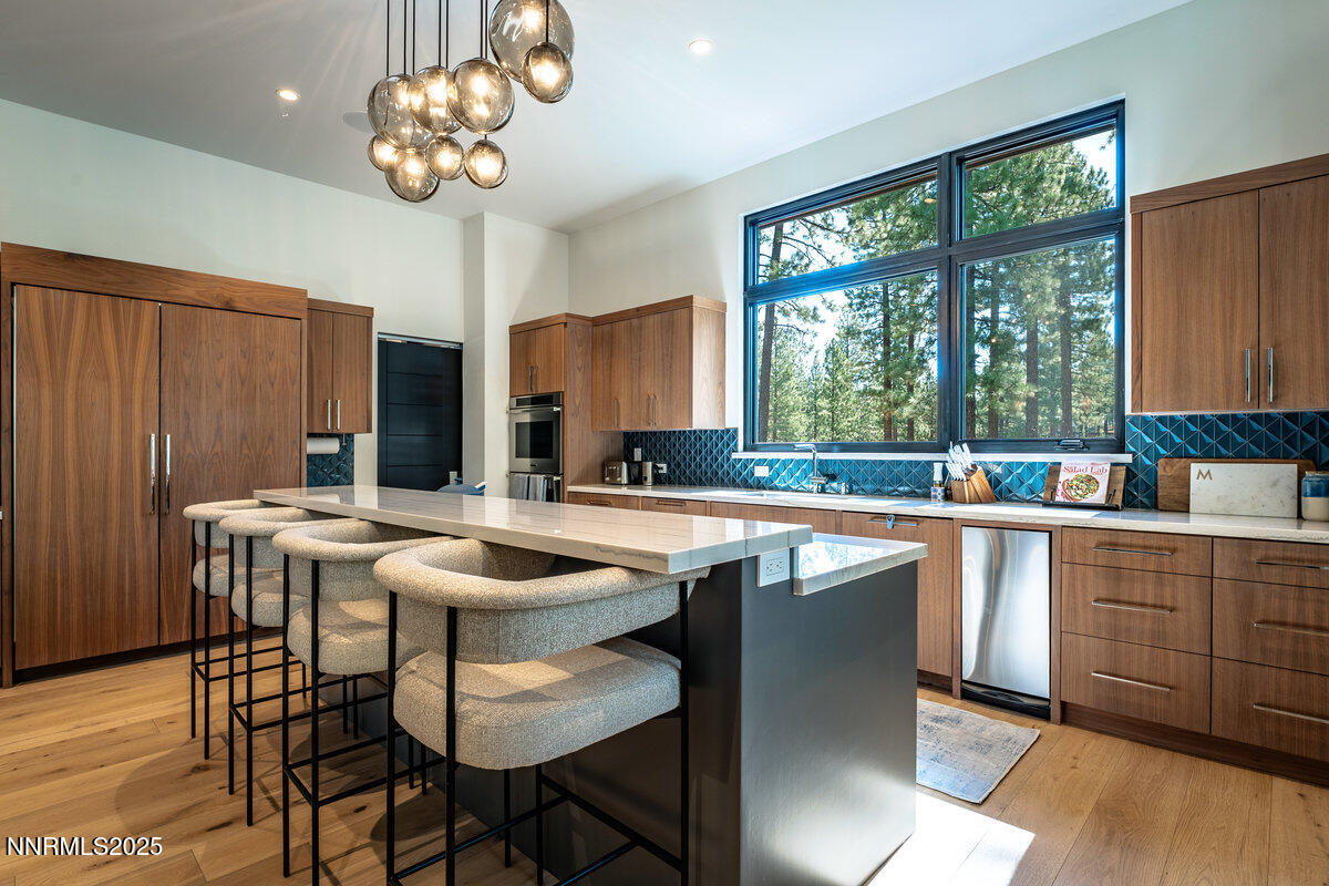 181 Redding Way Carson City, NV 89705 - Photo 6 of 40 a kitchen with a table chairs sink and cabinets