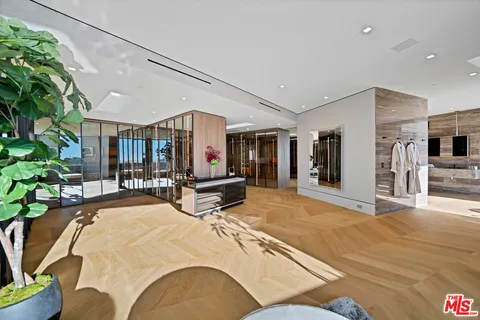 a view of a livingroom with furniture and floor to ceiling window