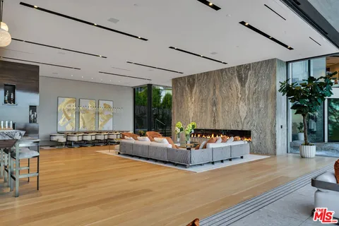 a living room with patio furniture and a floor to ceiling window