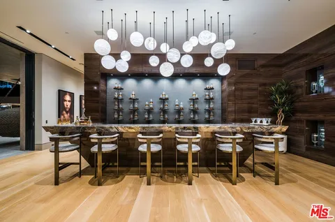 a kitchen with stainless steel appliances a dining table chairs and granite counter tops