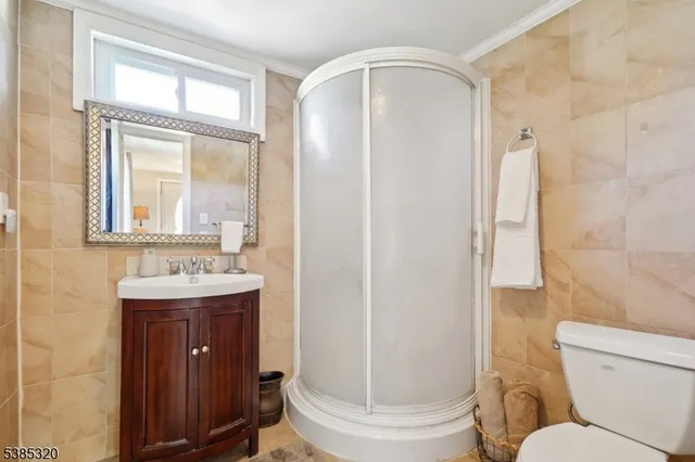 a bathroom with a toilet a sink and a mirror