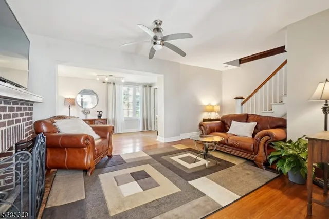 a living room with furniture rug and a flat screen tv