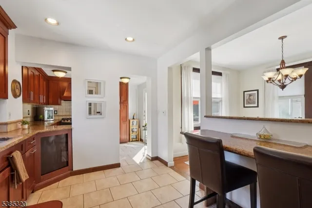 a living room with granite countertop furniture a dining table and chairs with wooden floor