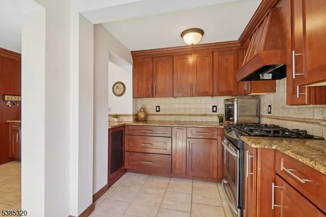 a kitchen with stainless steel appliances granite countertop a stove and a sink