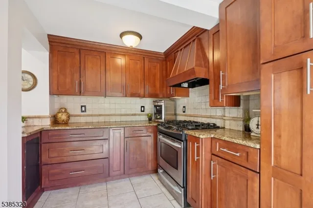 a kitchen with a stove sink and cabinets