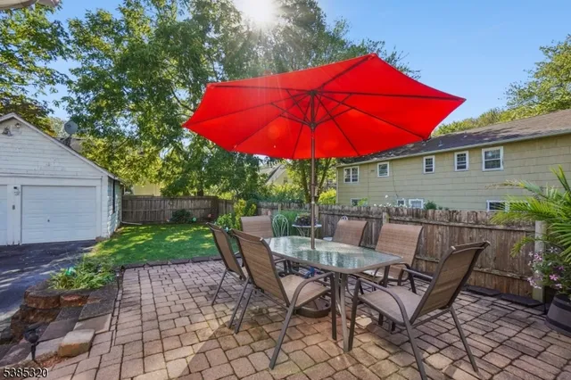 a view of backyard of house with yard and outdoor seating