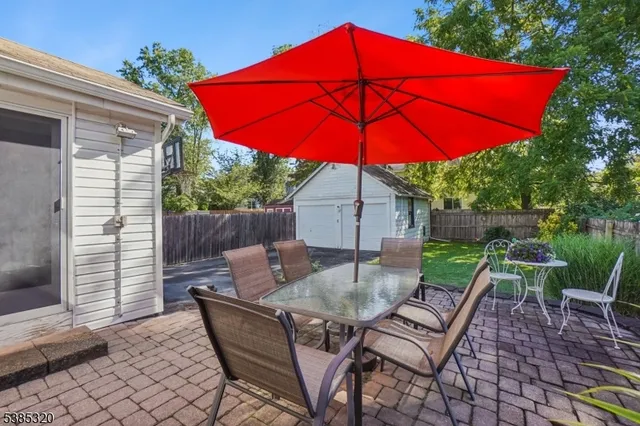 a view of backyard of house with seating space