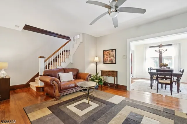 a living room with furniture a table and wooden floor