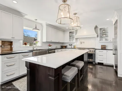 a kitchen with a table chairs stove and cabinets