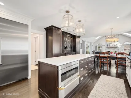 a large kitchen with a table and chairs
