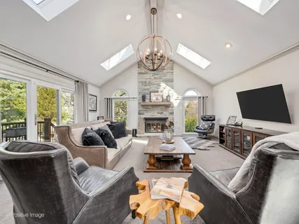 a living room with fireplace furniture and a flat screen tv