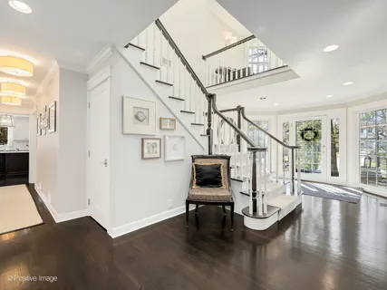 a view of entryway livingroom and hall with wooden floor