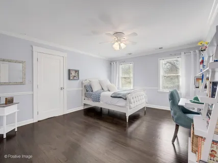 a spacious bedroom with a bed and a table in it