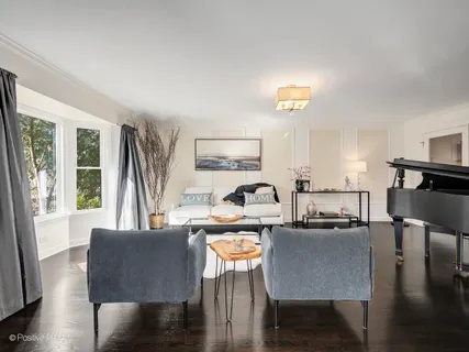 a living room with fireplace furniture and a wooden floor