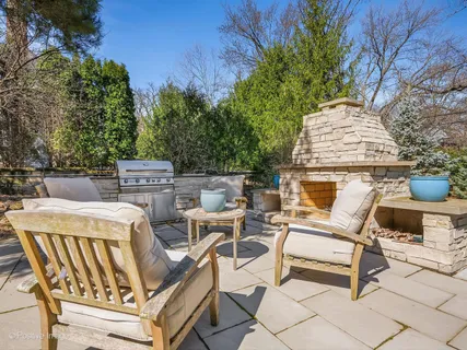 a view of a patio with table and chairs and potted plants